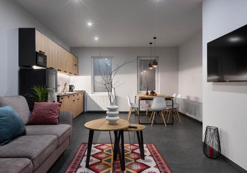 a living room and kitchen with a couch and a table at Apartel Shayan in Shaian
