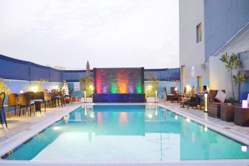 a large swimming pool with a large screen in a hotel at Dorus Hotel in Dubai