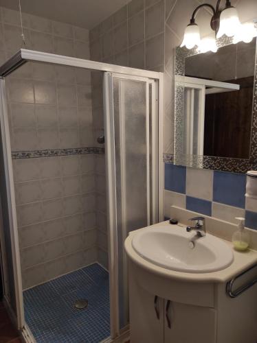 a bathroom with a sink and a shower at Puente Piedra in Carcabuey