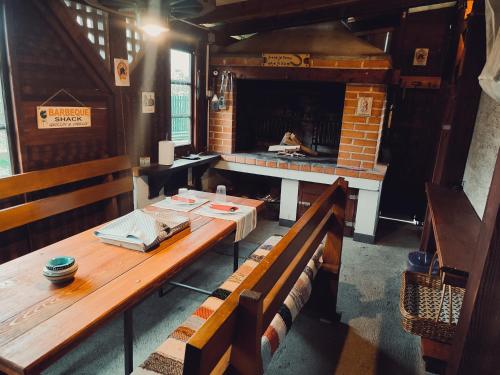 a dining room with a table and a fireplace at Apartment Nina-bazen-klima-parking in Otočac