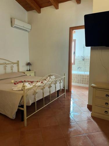 a bedroom with a bed and a tv in a room at Donnigheddu in Rudalza