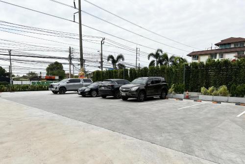 a group of cars parked in a parking lot at Golden Nest Hotel Suvarnabhumi in Bangkok