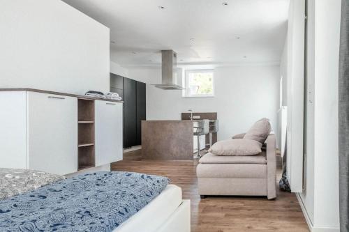 a room with a bed and a couch and a chair at Loft mit großer Terrasse bei der Kinderklinik 2C in Siegen