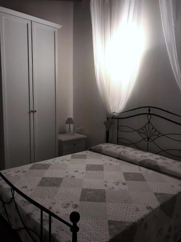 a bedroom with a bed with a quilt on it at Donnigheddu in Rudalza