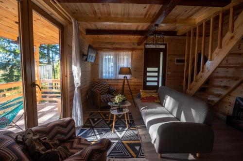 a living room with a couch and a table at Vilovi Botić in Nova Varoš