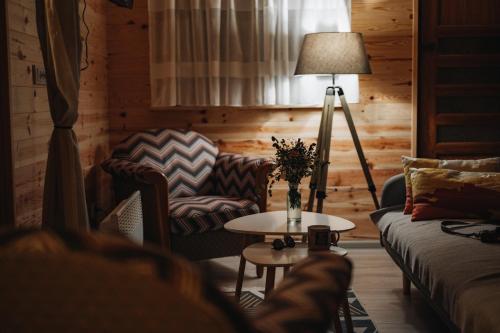 a living room with a couch and a table at Vilovi Botić in Nova Varoš