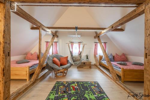 a room with two beds in a attic at Roubenka Výletní in Desná