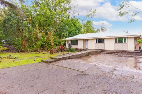 an empty parking lot in front of a house at Puni Mauka A 31 plus day rental in Pahoa