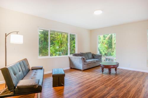 a living room with a couch and a table at Puni Mauka A 31 plus day rental in Pahoa