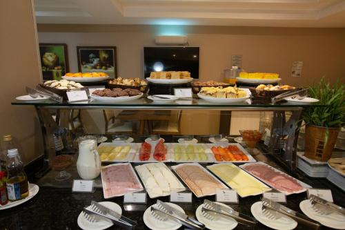 a buffet with many different types of food on a table at Viale Tower Hotel in Foz do Iguaçu