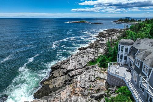 a house on a cliff next to the ocean at Barn at the Beach - Main House in Georgetown
