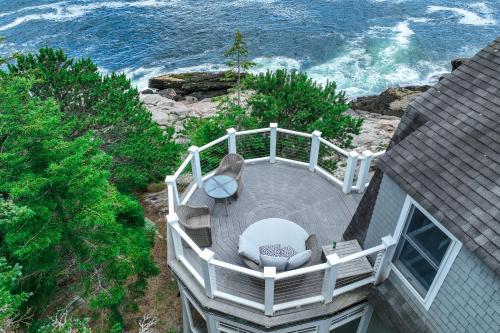 a deck with chairs and a view of the ocean at Barn at the Beach - Main House in Georgetown