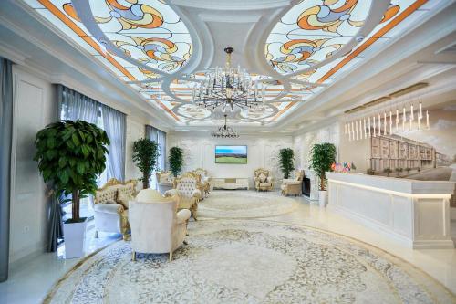 a large room with a chandelier and a living room at Royal Hotel Samarkand in Samarkand