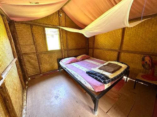 a small room with a bed in a tent at Twin Hut in Pai