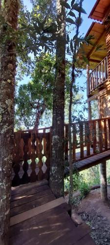 a porch of a house with trees and a deck at Cabaña en el Bosque de San José del Pacífico in El Pacífico