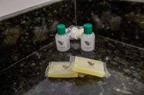 a counter with two bottles of soap on a counter top at Viale Iguassu Hotel in Foz do Iguaçu