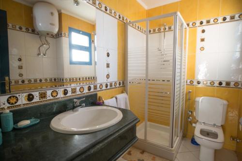 a bathroom with a sink and a shower and a toilet at Ras Katy Sunset Views in Sharm El Sheikh