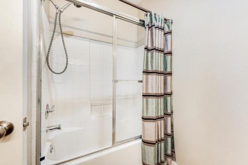 a shower in a bathroom with a shower curtain at Desert Breeze Villas #137 in Phoenix