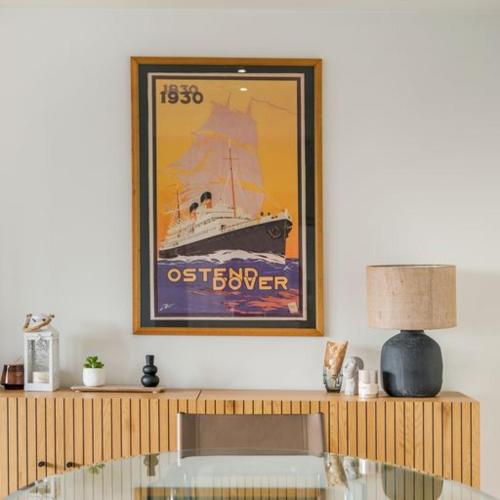 a living room with a picture of a boat on the wall at Unique Seaview close to Casino - garage available - "Monte Carlo" in Ostend