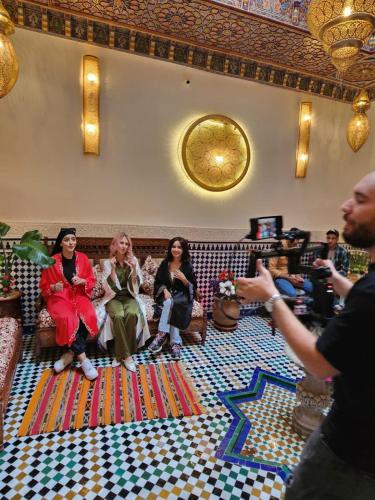 a group of people sitting on a couch in a room at Riad Dar Kassim in Fès