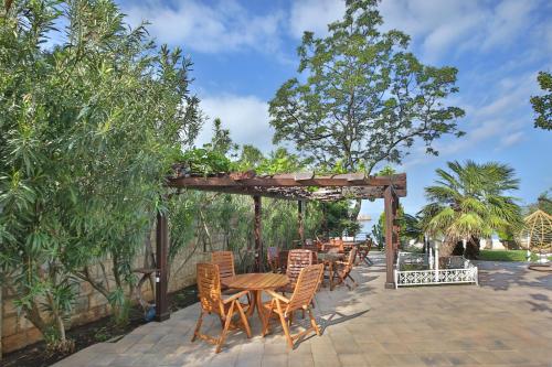 a wooden table and chairs on a patio at Royal Holiday Apartments Sveti Stefan in Sveti Stefan
