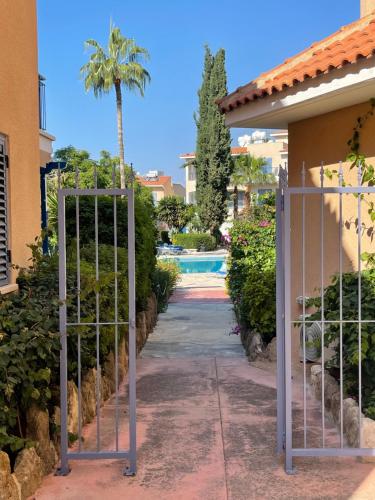 a gate leading into a yard with a pool at Rachel suite by the pool Paphos in Paphos City