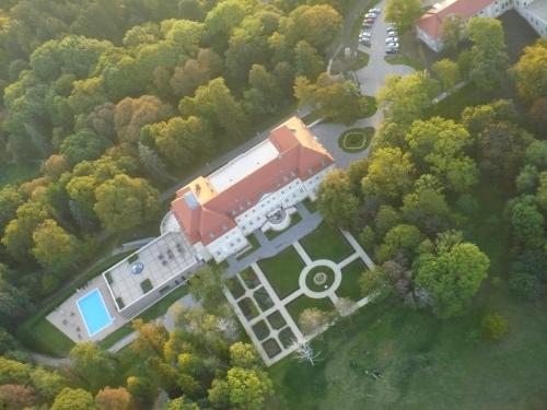 an aerial view of a building with a truck at La Contessa Castle Hotel in Szilvásvárad