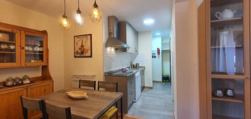 a kitchen with a wooden table and a dining room at Slalom BG Sierra Nevada in Sierra Nevada