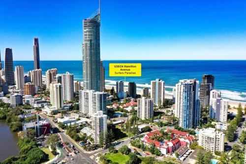 an aerial view of a city with a yellow sign at Coco Bella Dream in Surfers Paradise in Gold Coast