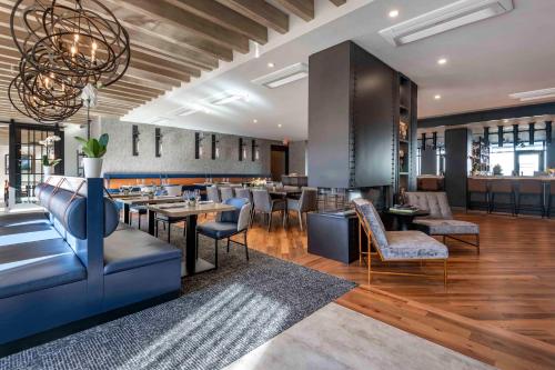 a restaurant with tables and chairs and a bar at Cambria Hotel Portland Downtown Old Port in Portland