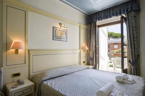 Postel nebo postele na pokoji v ubytování Hotel Poseidon