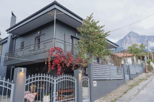 a black house with a fence in front of it at Country House in Ktistádes