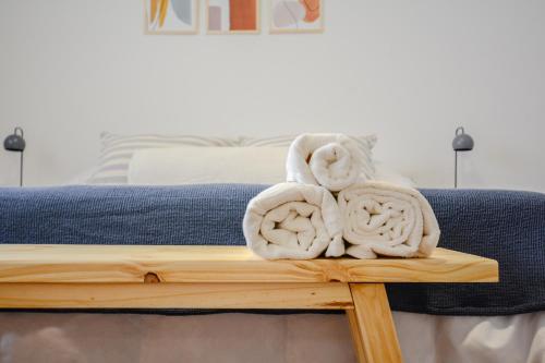 a bed with towels sitting on a wooden table at Anden Espejo in Mendoza