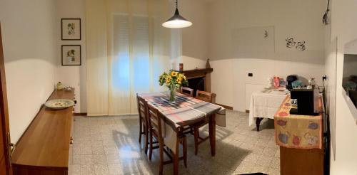 a kitchen with a table with a vase of flowers on it at B&B Camelia in Città di Castello