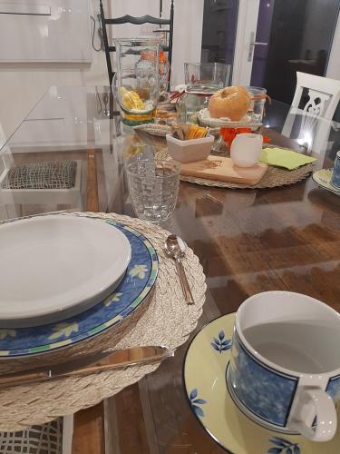 a table with plates and dishes on a table at B&B da Baba in Ghizzano
