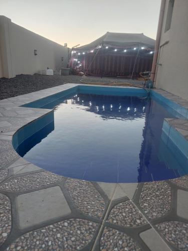 a swimming pool in the middle of a building at شاليهات رمال بديه in Al Raka