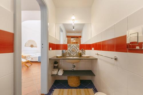 a bathroom with a sink and a mirror at TORRETTA CORRICELLA- Punta dei Monaci in Procida