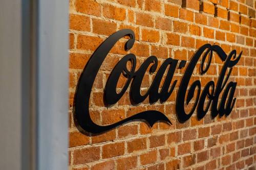 a sign on the side of a brick wall at Kluang Swimming Pool Blues 11 Retro Homestay in Kluang