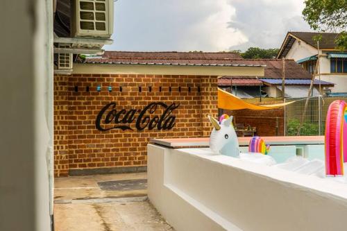 a view of a pool with a pool club sign on a building at Kluang Swimming Pool Blues 11 Retro Homestay in Kluang