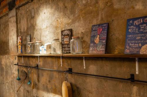 a shelf on a wall with jars and signs at Kluang Swimming Pool Blues 11 Retro Homestay in Kluang