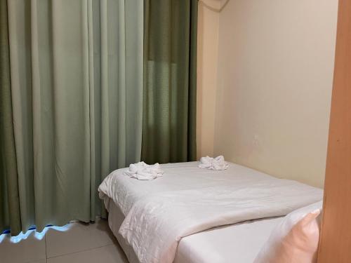a bed with towels on top of it in a room at Premiere Haven MOA Staycation in Manila