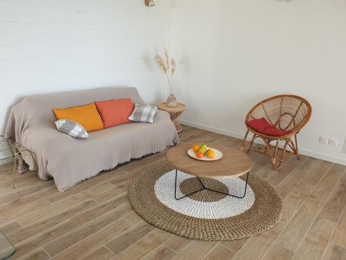 a living room with a couch and a table at Villa romantique, Rêve d'ailleurs, saint leu, la Réunion in Saint-Leu