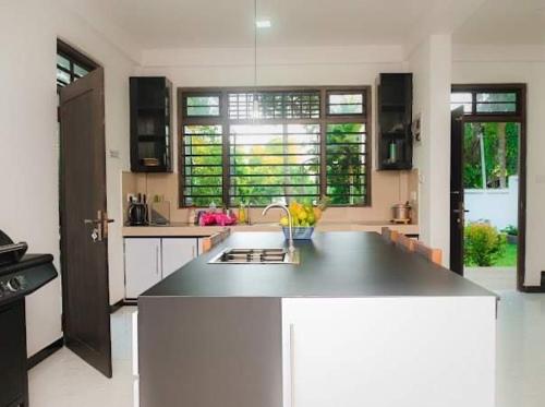 a kitchen with a large island in the middle at Villa Rukaththana UNAKURUWA in Tangalle