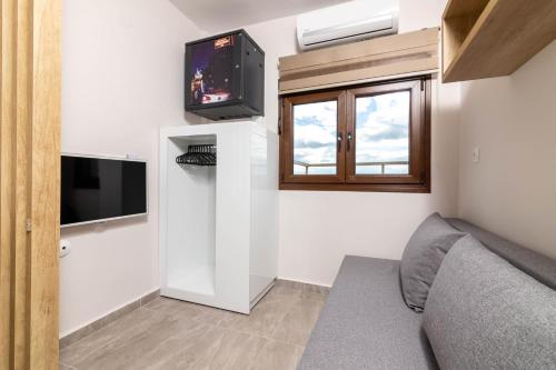 Televízia a/alebo spoločenská miestnosť v ubytovaní F & B Collection- 360 View Tiny Penthouse