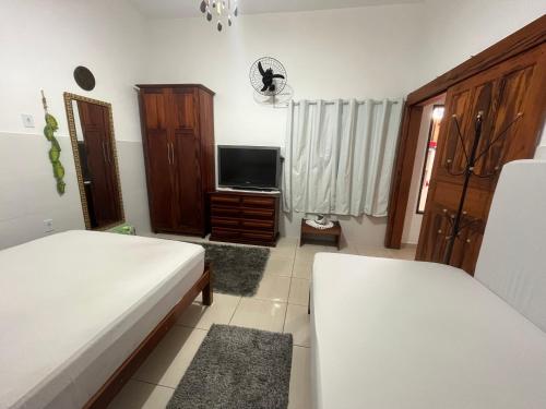 Ένα ή περισσότερα κρεβάτια σε δωμάτιο στο Hospedagem Villa Caiçara