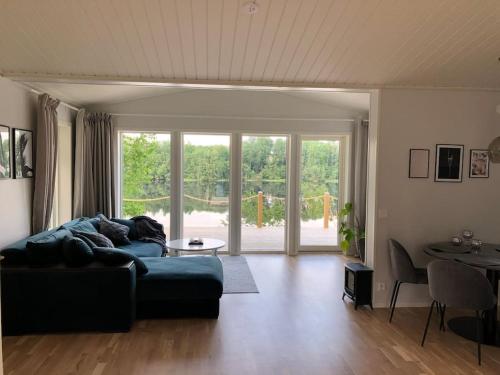 a living room with a couch and a table at Cottage by the river in Avesta