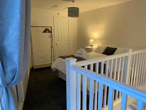 a bedroom with a bed and a white crib at Lodge in Plymouth