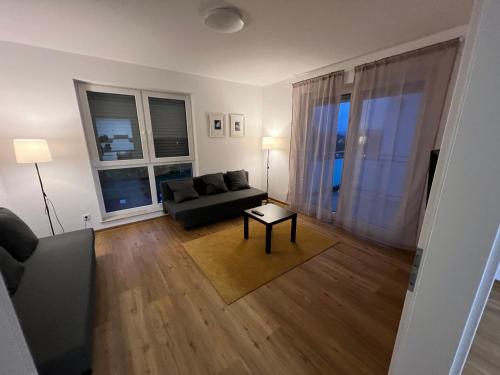 a living room with a couch and a table at ApartHotel Roxheim in Roxheim