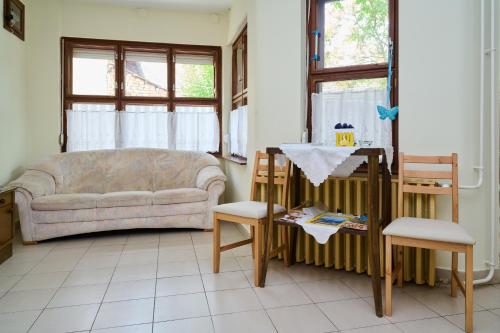 a living room with a couch and two chairs at Kölcsey Vendégház in Hódmezővásárhely