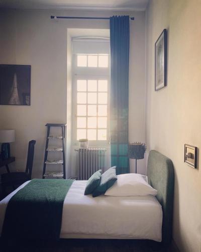 a bedroom with a bed and a window at Coeur de Calignac in Calignac
